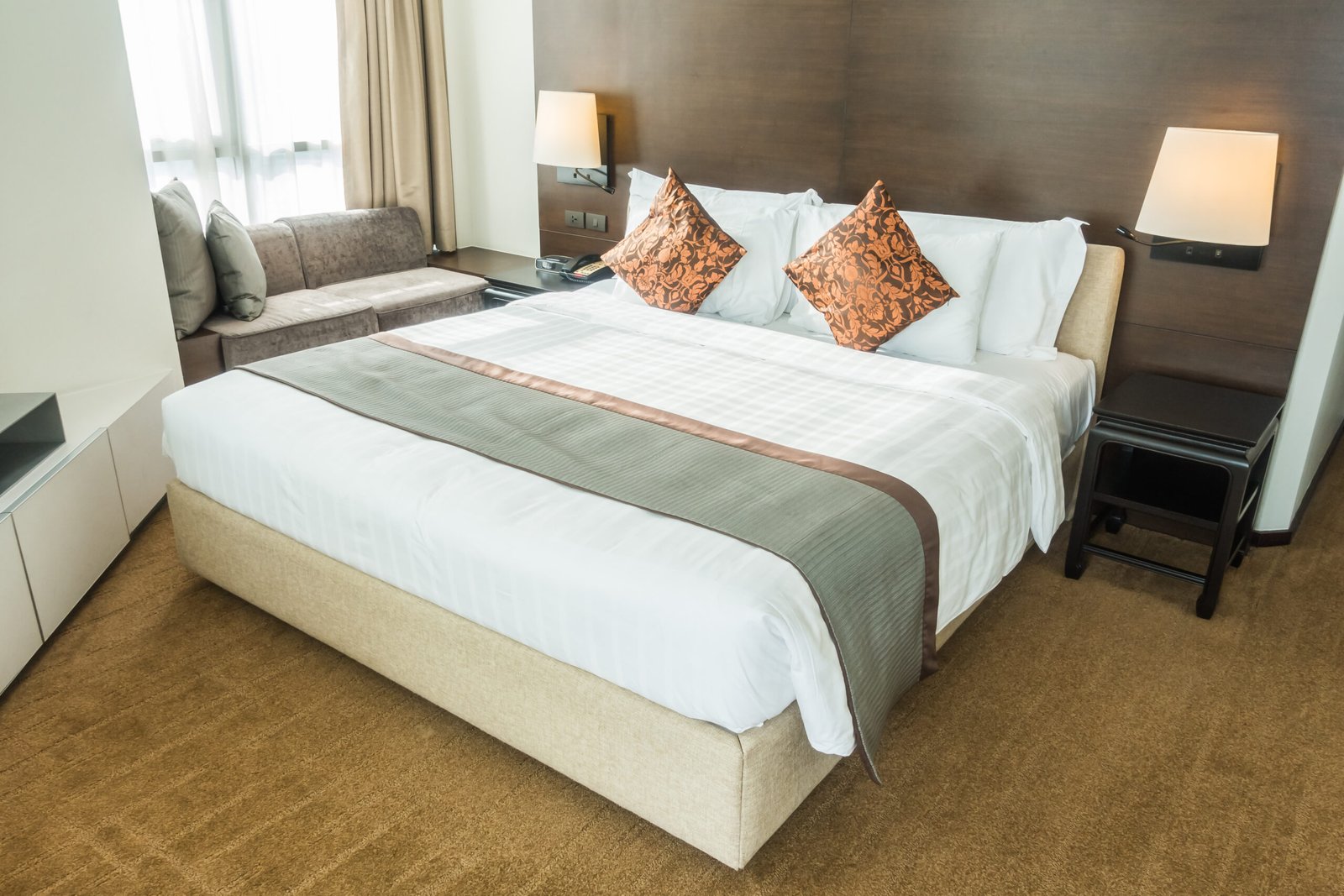 White pillow on bed decoration in bedroom interior with table light lamp